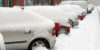 snow piled up on parked cars with gas prices rising