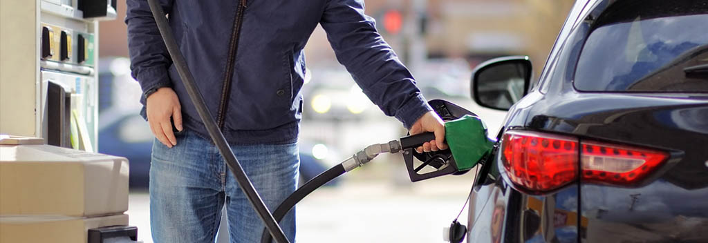 man pumping gas as price rises