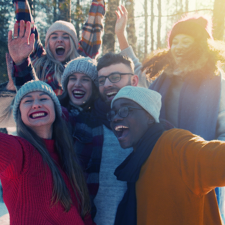 group of friends posing for a selfie in winter clothes