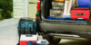 Packed suitcases and cooler in trunk of car